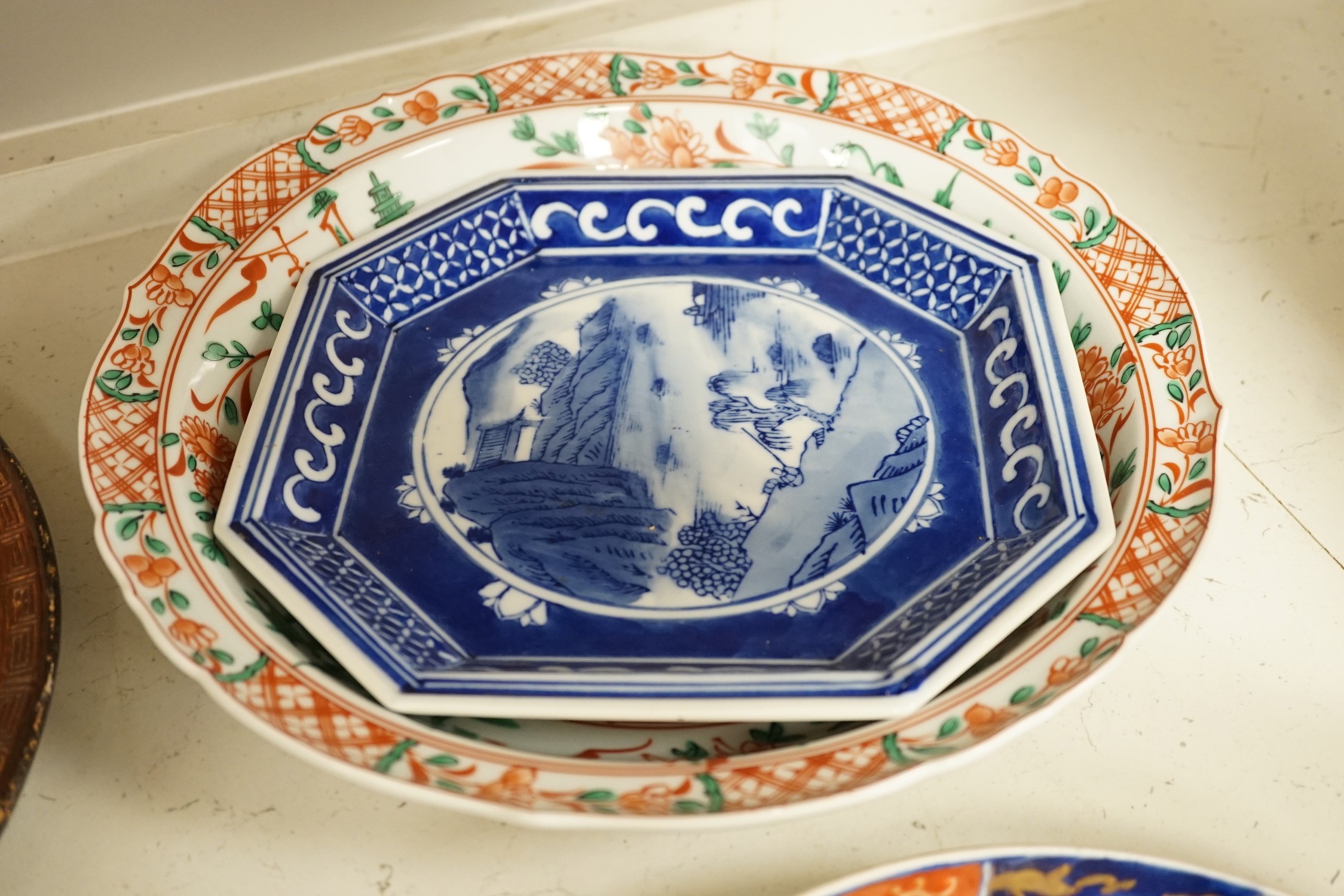 A group of 19th/20th century Japanese porcelain and pottery dishes. Largest 33cm diameter